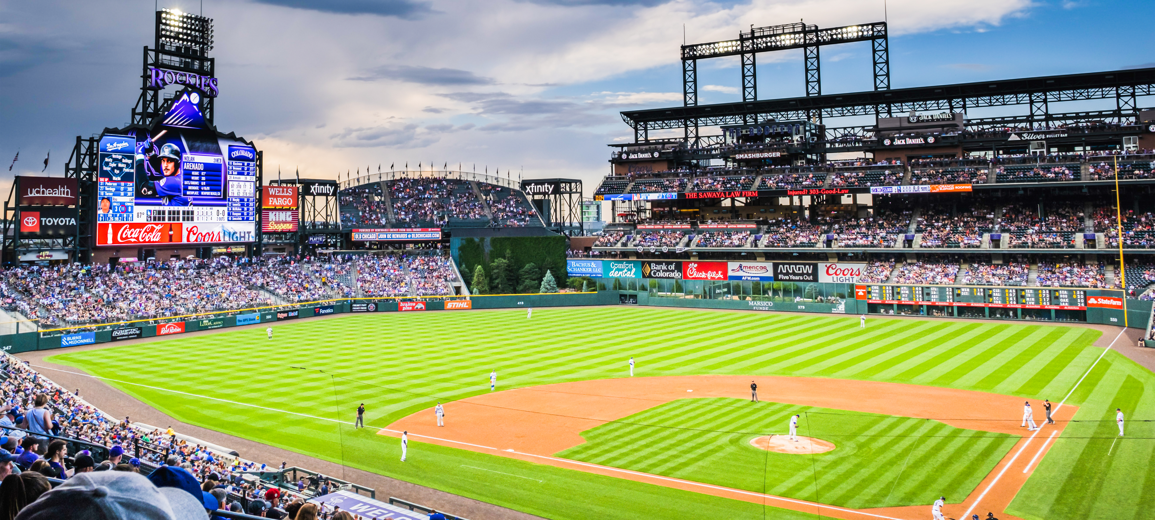 Coors Field during an evening baseball game as seen from the stands