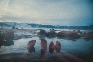 Relaxing in hot springs with feet out of the water