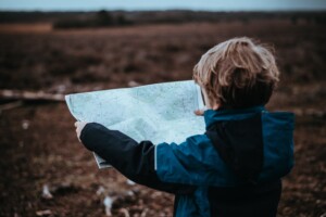 little boy reading map