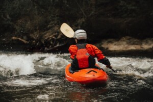 Man whitewater kayaking