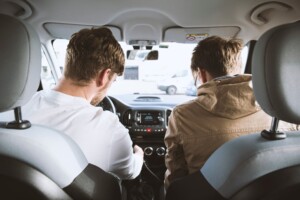 two men looking at car stereo