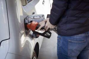 person filling up car gas tank